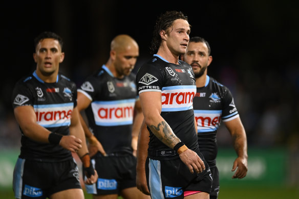 Nicho Hynes leads a dejected Cronulla side off the field after their loss to the Gold Coast.