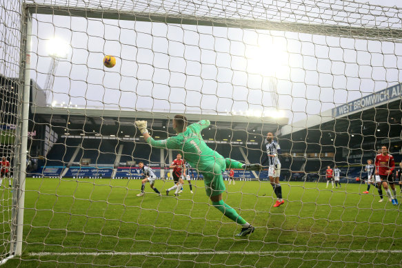 West Brom keeper Sam Johnstone saves a late Harry Maguire shot on goal for United.