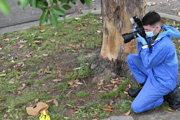 A forensic specialist takes a photo of a tan cap on Eildon Street in Doncaster.
