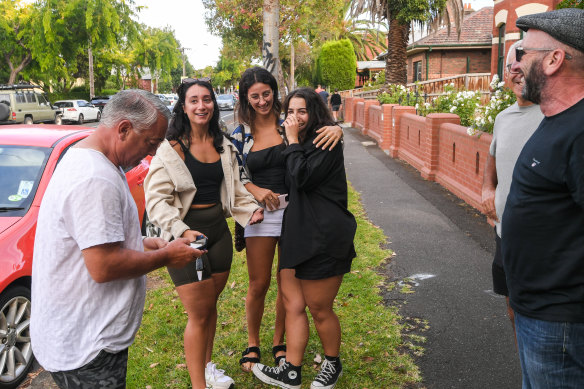 The buyers of 1/157 Holden Street celebrate with family.