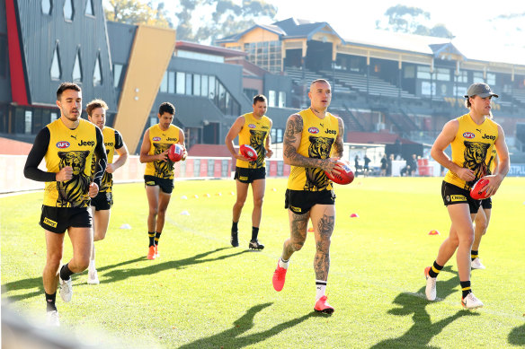 The Tigers run a lap of Punt Road Oval as training returns.