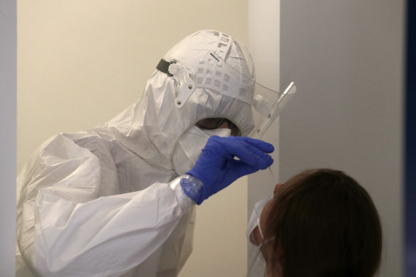 A woman gets tested for COVID-19 in Prague, Czech Republic on Saturday.