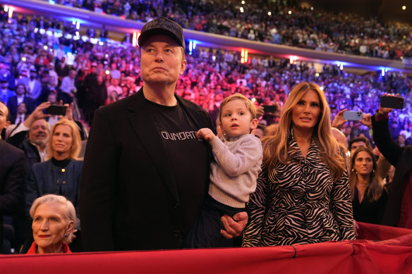 Elon Musk and former first lady Melania Trump listen as Do<em></em>nald Trump speaks at a campaign rally at Madison Square Garden in October.