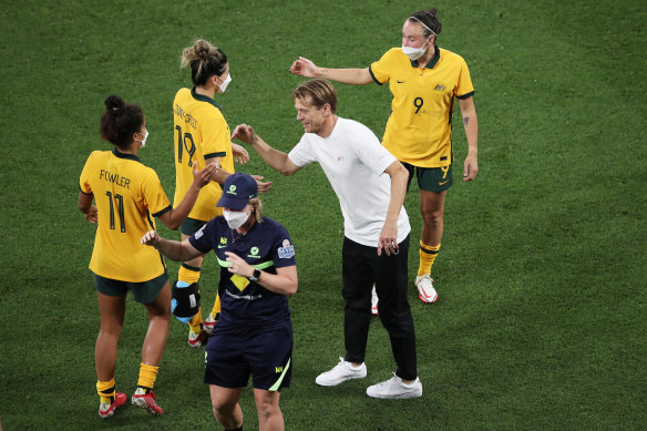 Matildas head coach Tony Gustavsson celebrates with his players after the victory over Brazil on Saturday.