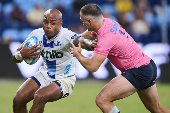 Mark Tele’a of the Blues is tackled