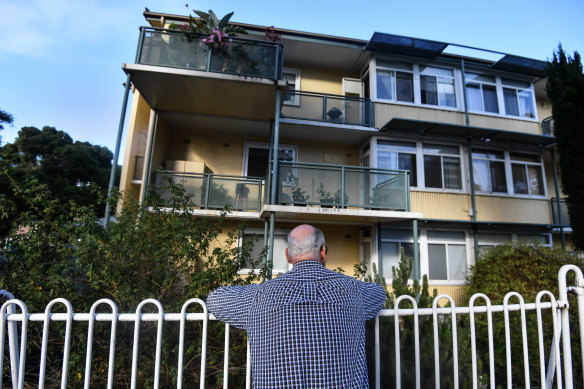 The North Melbourne estate in 2018, with a former resident, Les, looking at the public housing units where he lived for three decades.