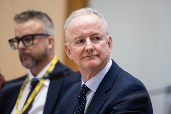 Justin Stevens (background) and Hugh Marks at an estimates hearing in December.