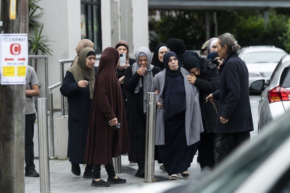 Close family of Mahmoud Ahmad are consoled after leaving the service at Lakemba Mosque.