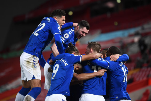 Everton’s Gylfi Sigurdsson celebrates with teammates Ben Godfrey, Michael Keane, Dominic Calvert-Lewin and Abdoulaye Doucoure after scoring his team’s second goal against Liverpool. 