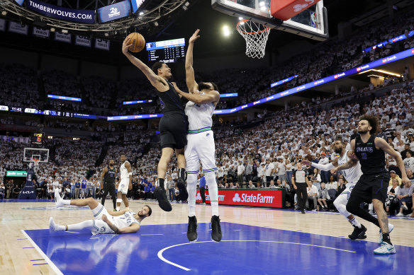 Josh Green attempts a dunk against Karl-Anthony Towns of the Minnesota Timberwolves during the play-offs.