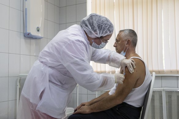 A Russian healthcare worker administers the vaccine to a volunteer in Moscow in September.