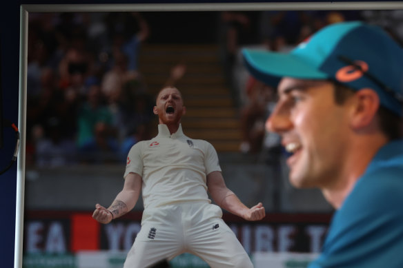 Pat Cummins speaks in front of a photo of Ben Stokes.