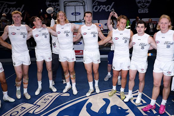 The Cats sing the team song.
