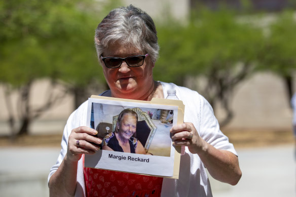 Hilda Reckard, the daughter-in-law of victim Margie Reckard, holds a picture of her outside court.