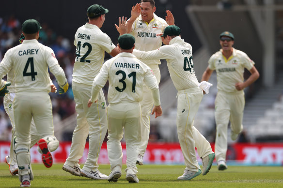 Scott Boland and Australia celebrates a wicket.