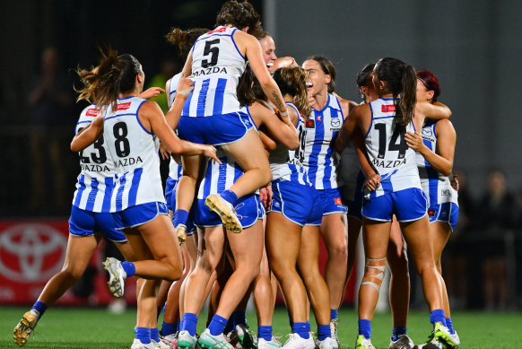 The Kangaroos celebrate their premiership win.