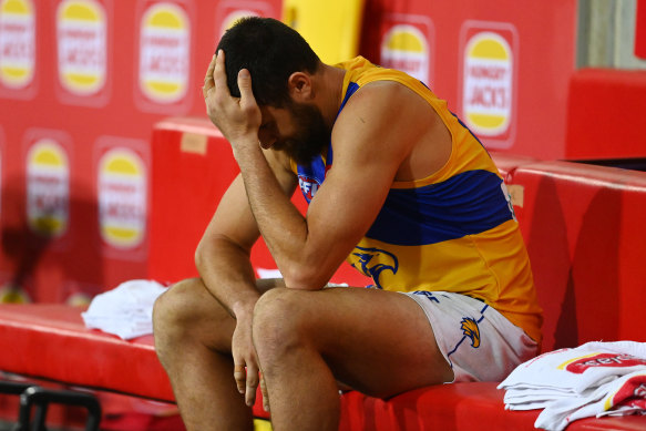 A dejected Eagles forward Josh Kennedy sits on the bench.