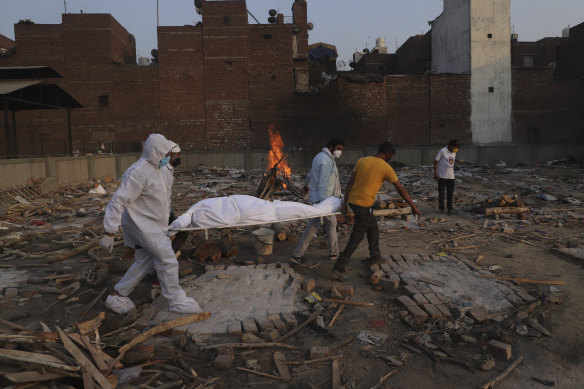 Family members and volunteers carry the body of a COVID-19 victim before cremation in New Delhi in May.