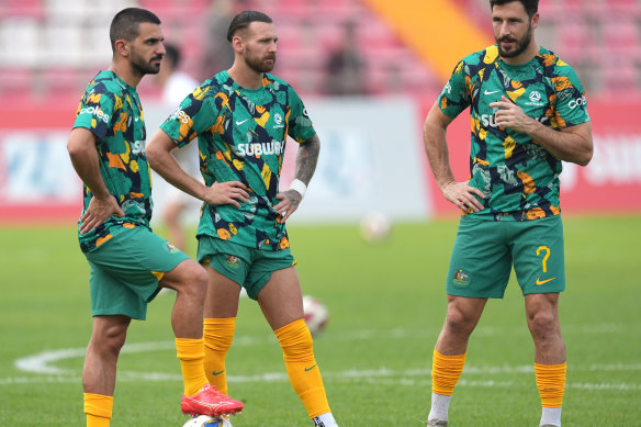 Aziz Behich, Martin Boyle and Mathew Leckie look on.