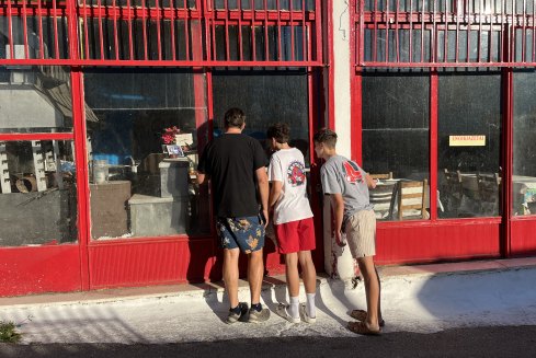 Kari Gislason and his two sons peer into the taverna once owned by the Pirate.
