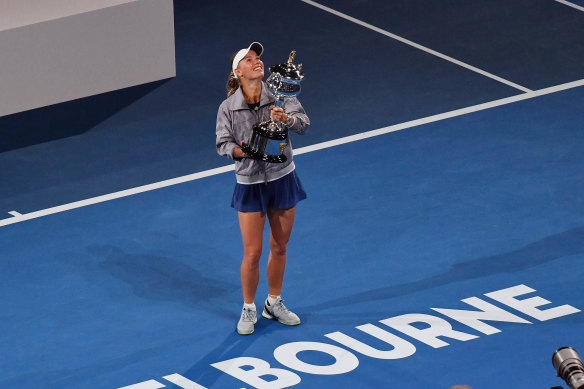 Caroline Wozniacki celebrates with the trophy after beating Simona Halep in the Australian Open women's final  in 2018.