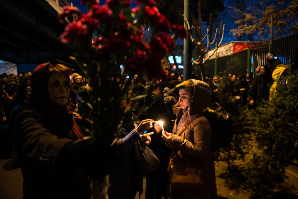 Demonstrators light candles on Saturday while gathering during a vigil for the victims of the Ukraine International Airlines flight that was unintentionally shot down.