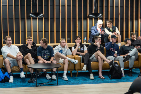 North Melbourne players listen to new coach Alastair Clarkson at his first press conference at the club.