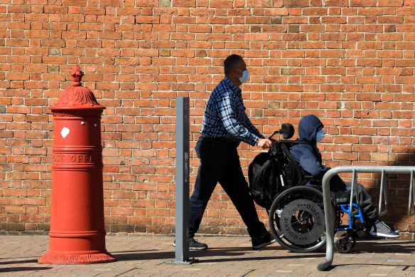 People wear face masks near Liverpool Hospital.