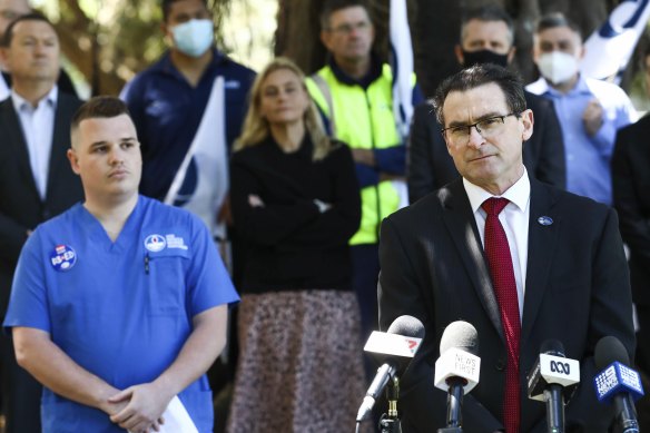 NSW Nurses and Midwives’ Association general secretary Brett Holmes with hospital emergency department nurse Josh who was diagnosed with COVID-19 and received workers’ compensation cover without having to prove he was infected at work.