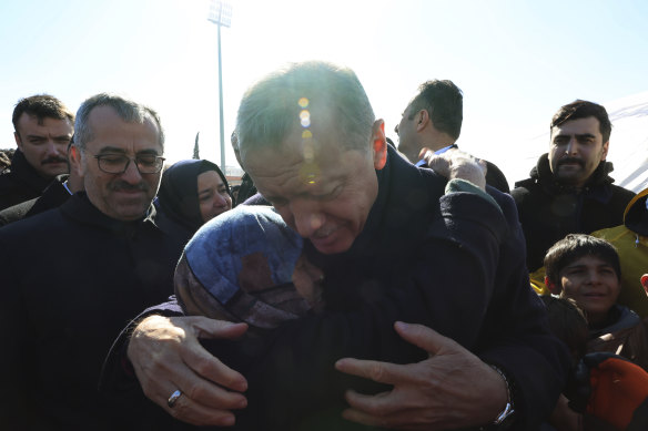 Turkey’s President Recep Tayyip Erdogan and a survivor hug each other in Kahramanmaras, southern Turkey. 