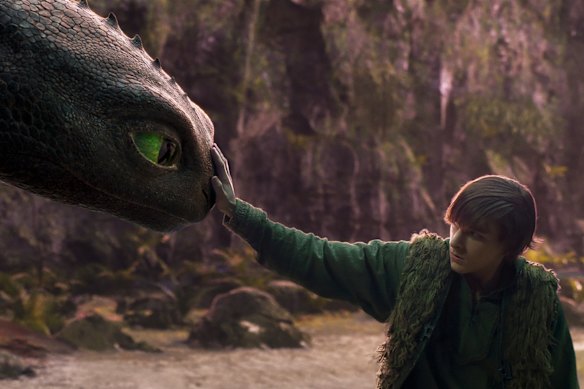 Hiccup (Mason Thames) meets his Night Fury dragon, Toothless, in How to Train Your Dragon.