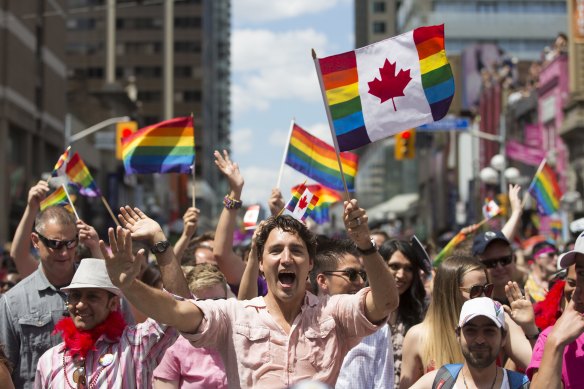 Canadian Prime Minister Justin Trudeau waves a flag at Toronto Pride in 2016.