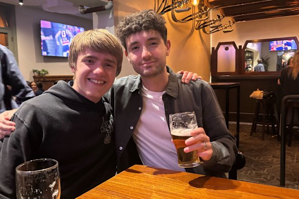 Liam and Lewis watch on from a pub.