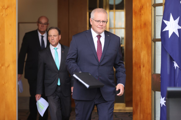 Prime Minister Scott Morrison and Health Minister Greg Hunt address the media in February about their vaccination strategy.