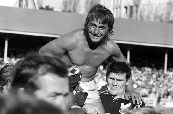 Manly captain and hooker Fred Jones is chaired from the field by teammate Bill Hamilton. 16 September 1972.