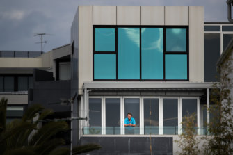 Neill Fitzpatrick on the balcony of his Port Melbourne apartment. Rates on his property have not fallen, despite cladding needing to be rectified on it.