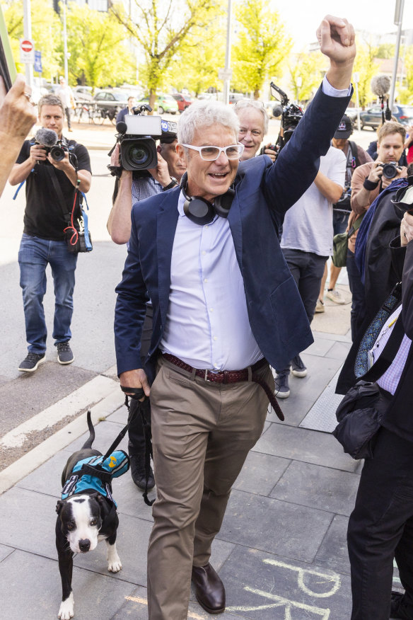 Arriving at the ACT Supreme Court with his therapy dog, Jakey, for his 2023 trial.