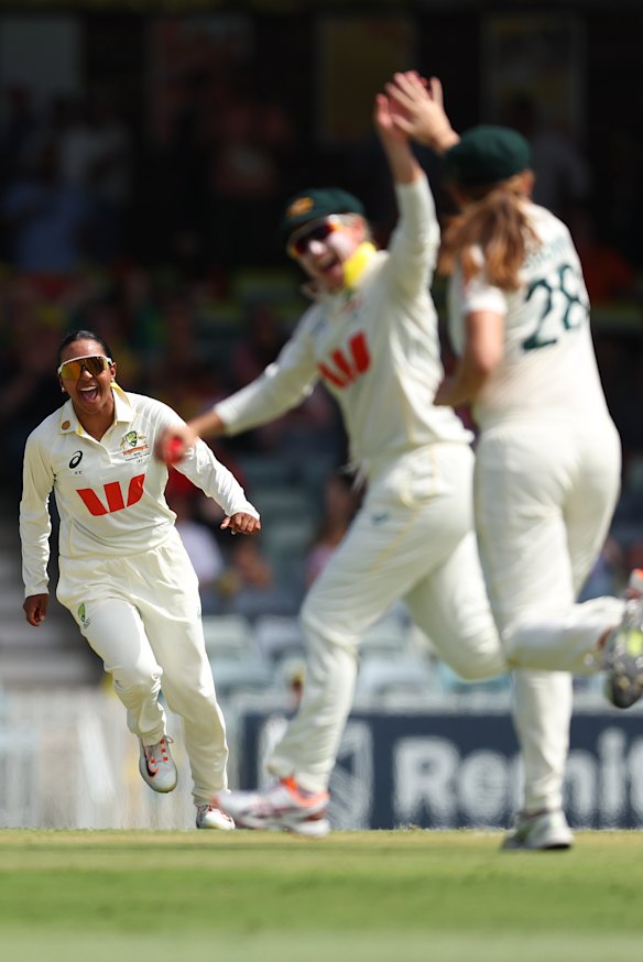 The Australians are overjoyed as Alana King (left) claims a wicket.