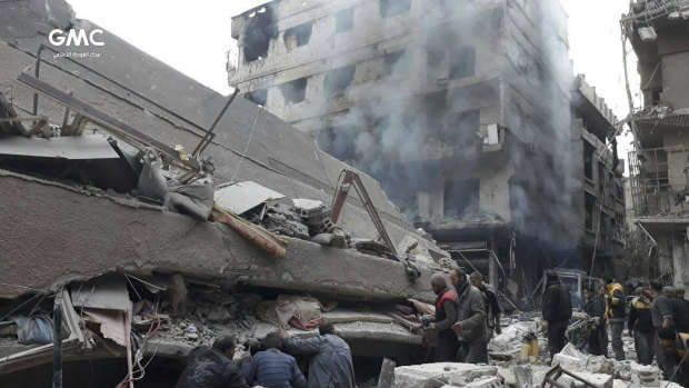 Syrians search for victims under the rubble of a destroyed building in Ghouta.