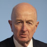 Macquarie chair Glenn Stevens warns on inflation as profits take a hit