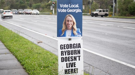 A corflute critical of Georgia Ryburn under her official Liberal Party one on Mona Vale Road.