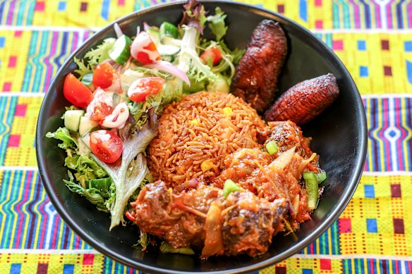 Liberian jollof rice made with jasmine instead of basmati rice, beef, fried plantains, and a dressed salad.