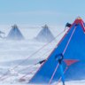 Dr Yixi Zheng from the British Antarctic Survey removes snow from her tent on the Thwaites Glacier.