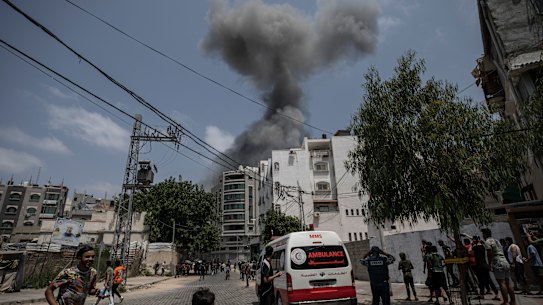 Smoke rises after Israeli airstrikes on residential building, in Gaza City, on Saturday.