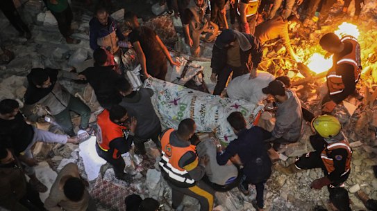 People inspect damage to their homes caused by Israeli air strikes on December in Rafah, Gaza. 