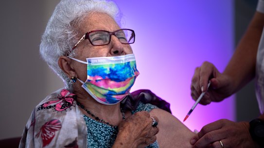 Rachel Gershon, 83, receives a third Pfizer-BioNTech COVID-19 vaccine from a Magen David Adom national emergency service volunteer, at a private nursing home in Netanya, Israel, Sunday, August 1, 2021.