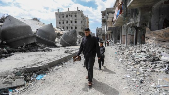 Palestinians pray during the second Friday prayer of the holy month of Ramadan on the ruins of Al-Farouq Mosque in March.