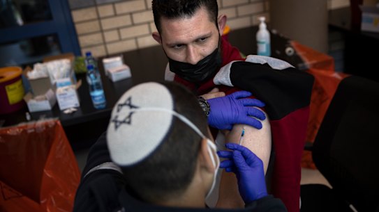 Israeli medical teams administer the Pfizer-BioNTech COVID-19 vaccine to Palestinians at the Qalandia checkpoint between the West Bank city of Ramallah and Jerusalem this week.