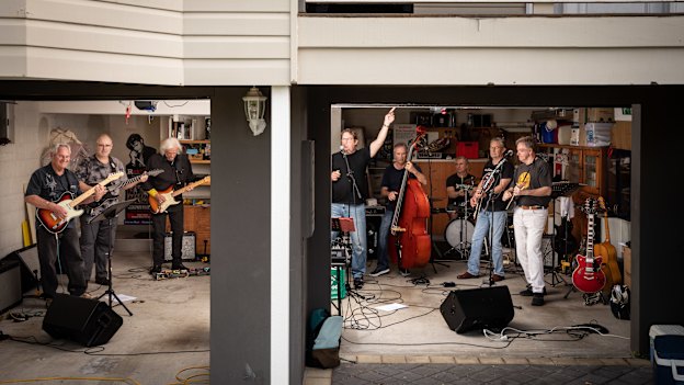 Highly Strung, which includes the writer’s husband, David Fagan (at far right), rehearses in a Brisbane garage. Band member Kenn McCall (second from right) says it’s like joining a sporting team.