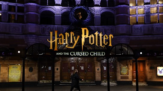 A pedestrian walks past a theatre in the West End district in London in March. 